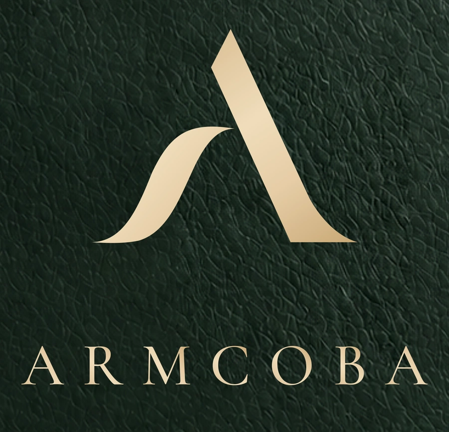 Original ARMCOBA emblem and wordmark in champagne on forest-green leather